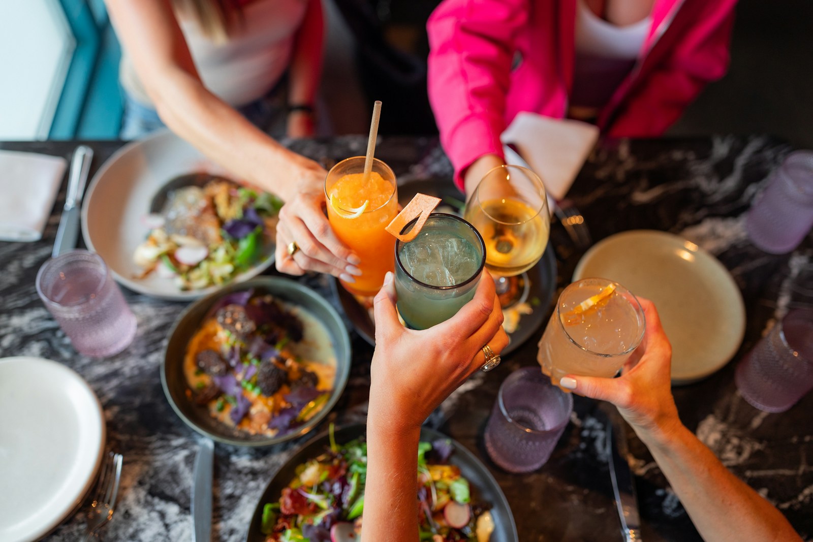A group of friends sharing a meal at a restaurant table