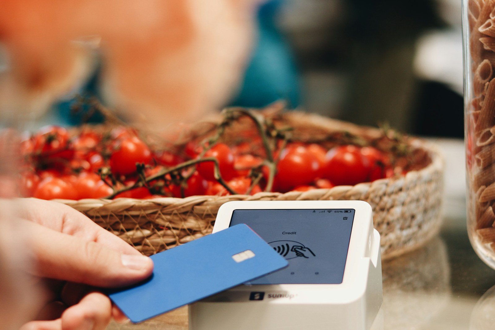 A customer making a contactless card payment at checkout